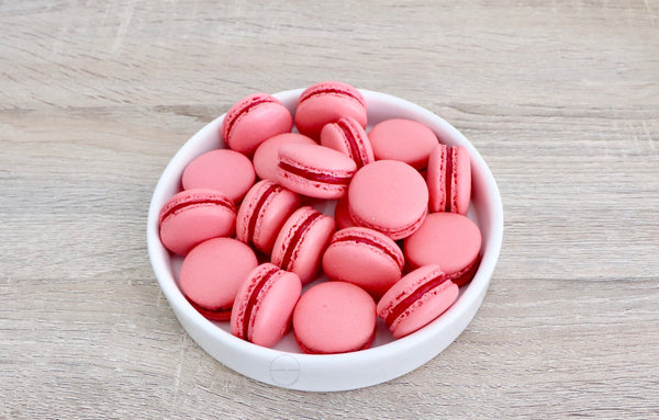 Raspberry filling in a deep pink coloured macaron